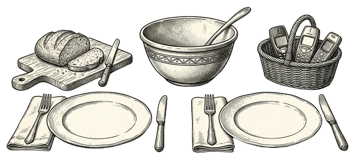 An ordinary evening meal table with empty place settings, warm light, shared serving bowl, and a phone basket set outside the dining area