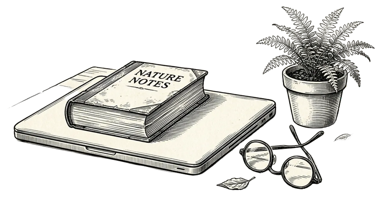Engraving of a closed laptop with a book resting on top, reading glasses folded beside, and a small potted plant on a quiet desk